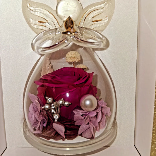 Violet  purple rose preserved in an angel glass figurine