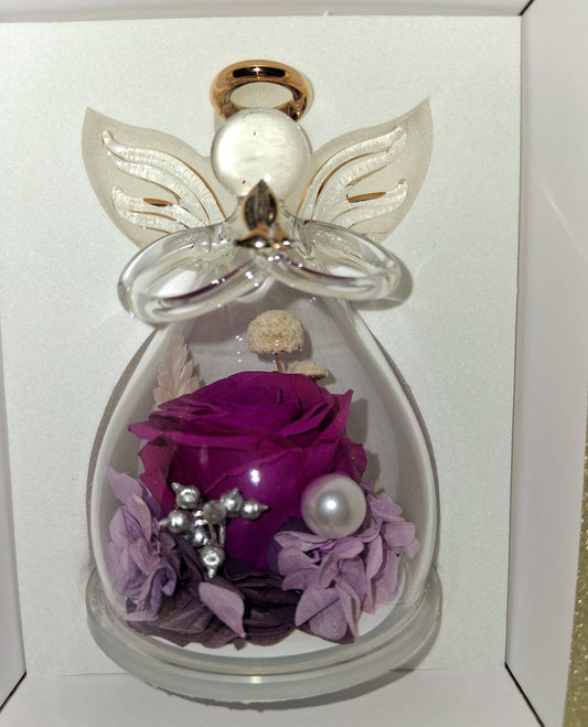 Purple rose preserved in an angel glass figurine